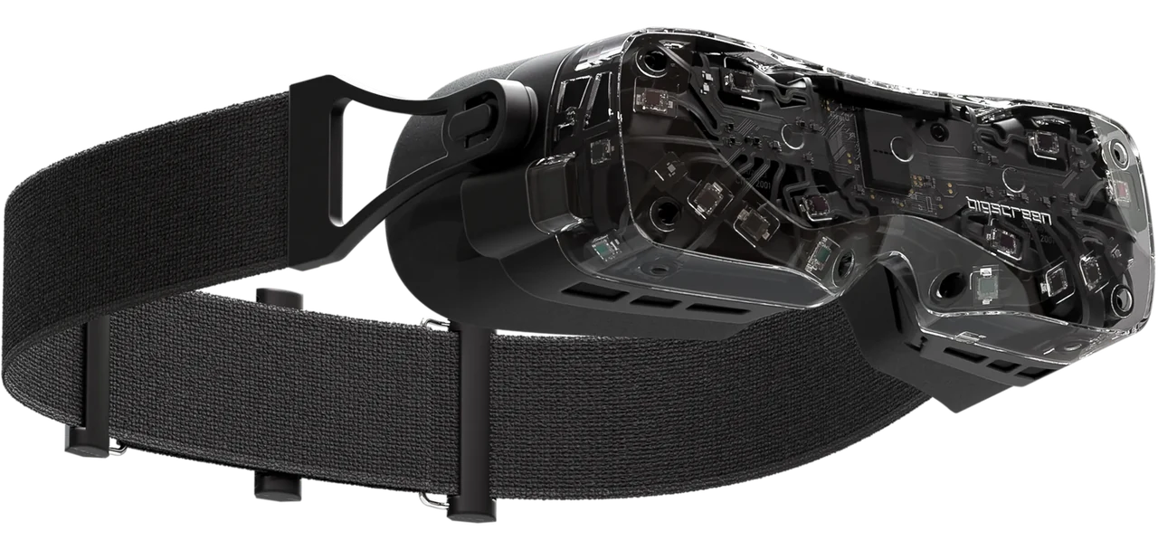 The Bigscreen Beyond 2 in its transparent shell, showing the sparse circuit boards and components inside a headset roughly the size of a pair of ski goggles