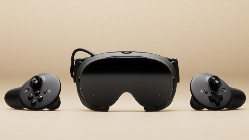 Valve Steam Frame headset shown from the front between its two controllers on a beige background
